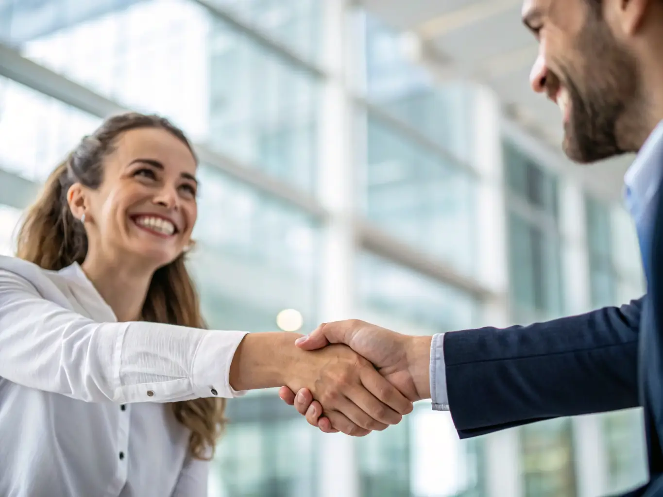 A handshake between a satisfied client and a Landhaven representative, symbolizing a successful land sale.